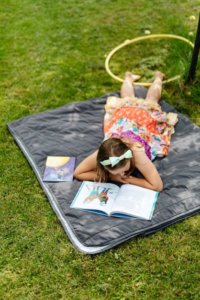 child reading outside school