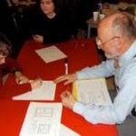 Melvin Ramsden from Real Spelling helps students fill out a worksheet