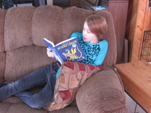 Anna H Reading on her couch after completing a year of Lexercise