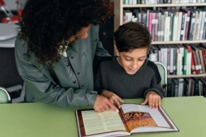 teacher reading with student