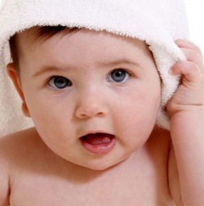 Baby with a  towel on their head 