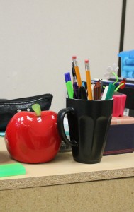 teacher's desk with an apple, pencil cup holder