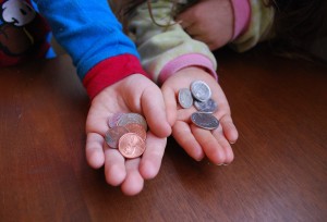 kids hands showing coins