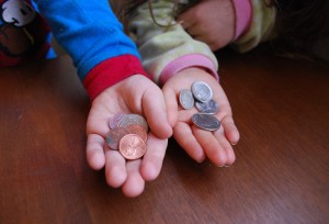 kids hands showing coins