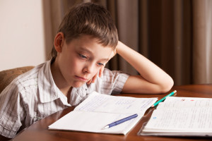 child frustrated at home with too much homework