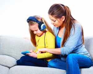 mother and daughter at home listening to audiobooks