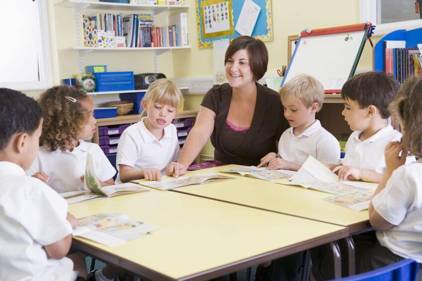 teacher with kids in white shirts