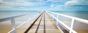 Boardwalk stretching across sand and across the sea