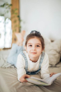 child reading a grade level book at home