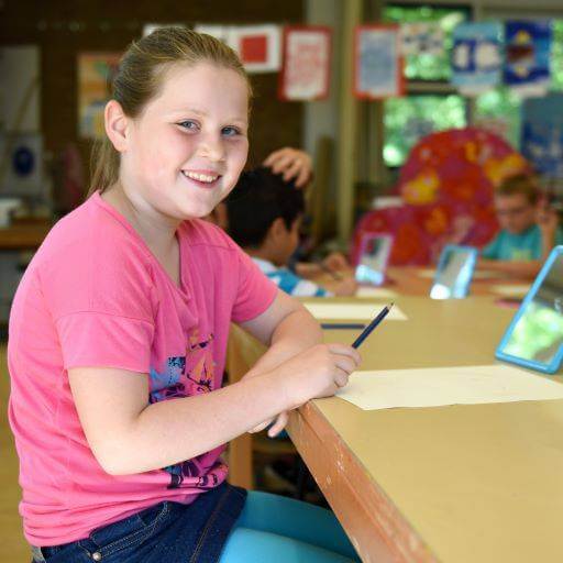 child in classroom taking the Mississippi dyslexia screener with their teacher and peers