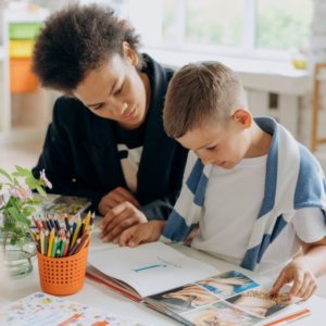 dyslexic child learning t o read with teacher